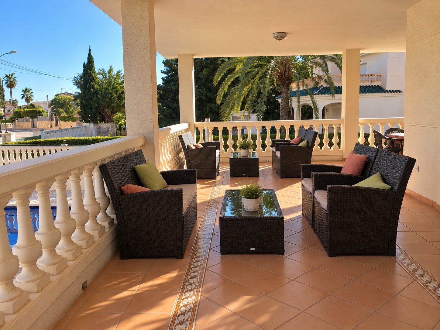Shaded villa terrace with a table and chairs